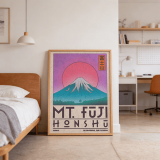 Print leaning on the floor featuring Mt Fuji art print with pink sun and blue mountain near a bed