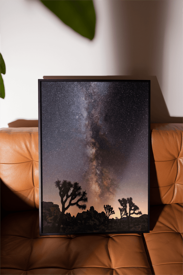 Night Desert Poster framed print with milky way over desert trees on a brown leather seat