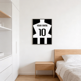 Football Shirt Poster in Black and White Stripes with Black Sleeves above a wooden bedside table in a bedroom