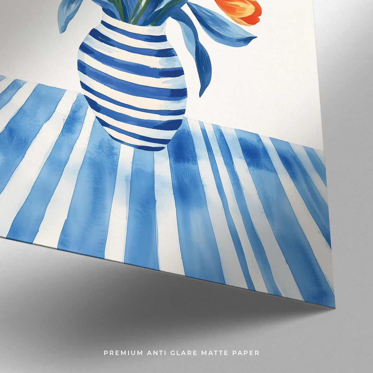 Close-up of tulip wall art showing striped blue vase and tablecloth with orange tulip petals