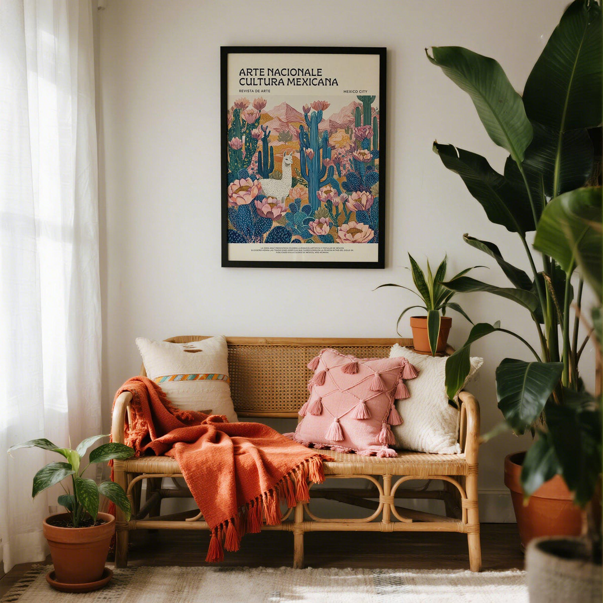 Mexican wall decor print of a white llama in a colourful desert scene above a sofa with cushions and blanket