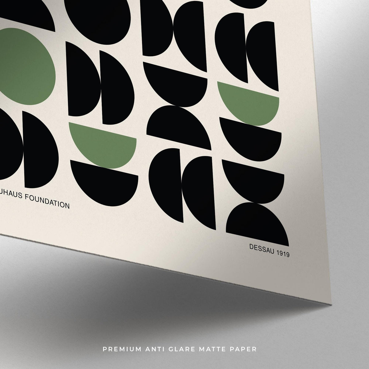 Gallery print close-up showing black and green geometric abstract shapes on matte paper