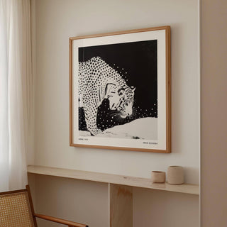 Japanese Tiger Art print of a spotted tiger in black and white on a beige wall above a wooden shelf with two pottery vases