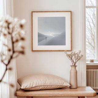 Gray and White Wall Art in a living room featuring a person on a winding path in soft grey tones with a dried flower vase on a wooden bench