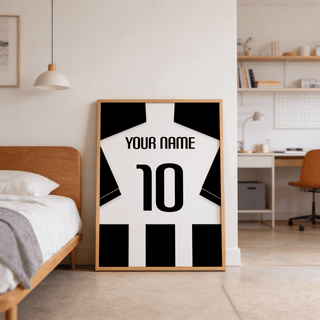 Football Shirt Poster in Black and White Stripes with Black Sleeves leaning on the floor next to a bed in a bedroom