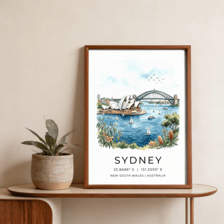 Framed Sydney Watercolor Art Print of Opera House and Harbour Bridge with blue waters on a wooden table