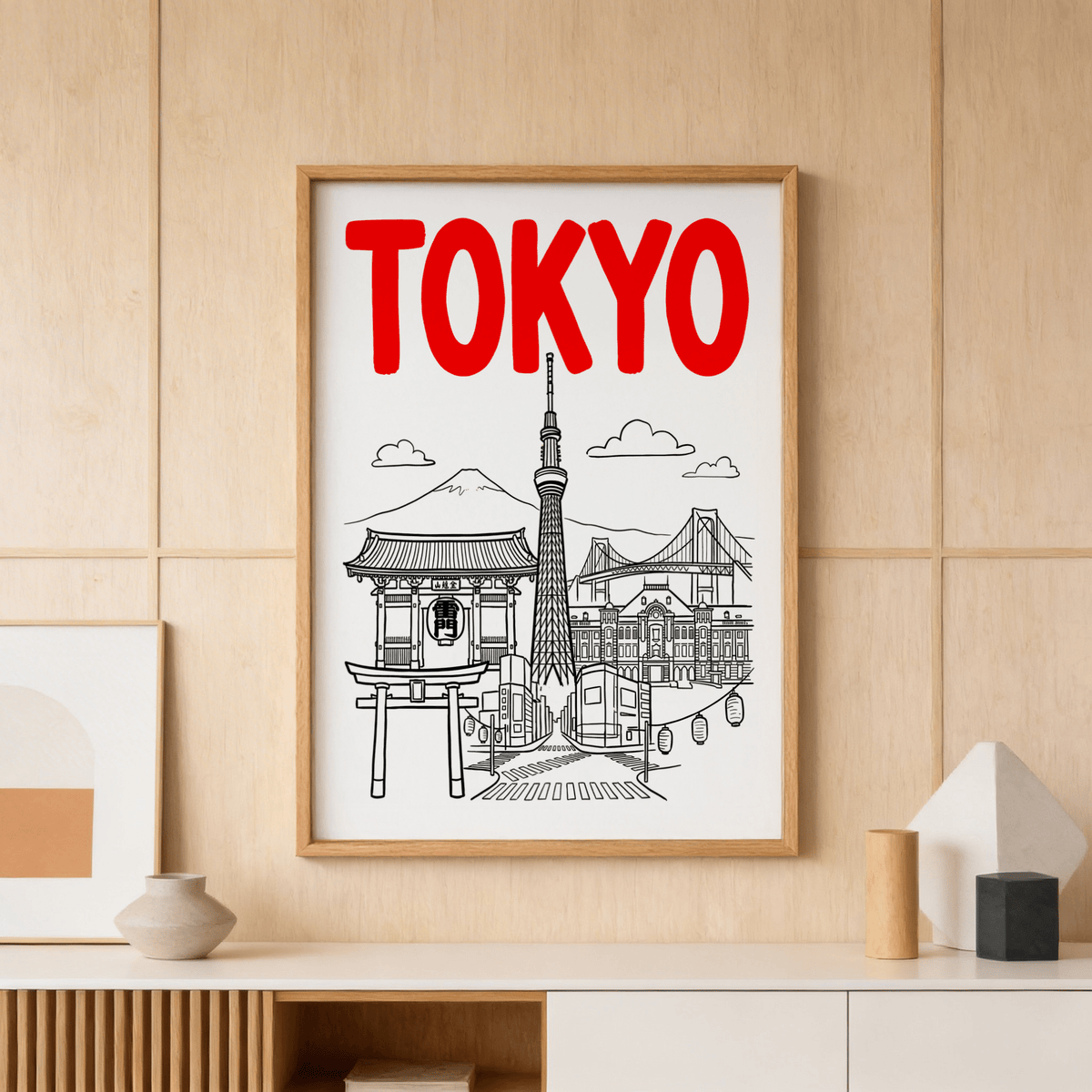 Tokyo City wall art with red text and black line-art landmarks above a shelf with vases