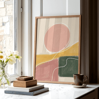 Modern Abstract Print leaning on a window sill with books and a mug nearby