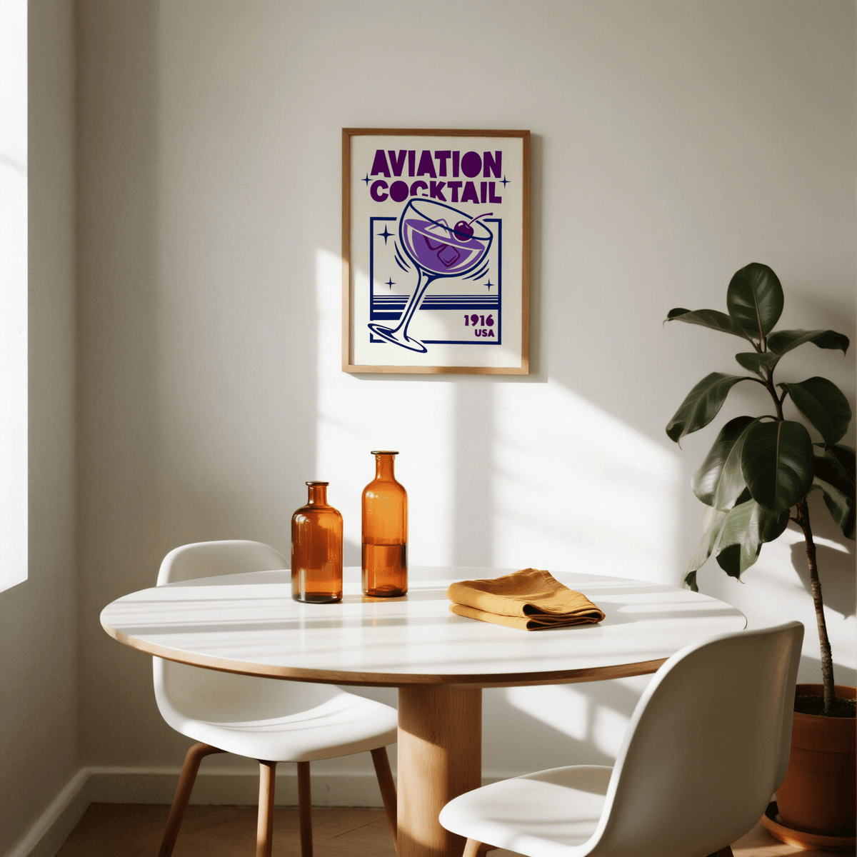 Aviation Cocktail Print on wall in dining room above table with amber glass bottles and plant