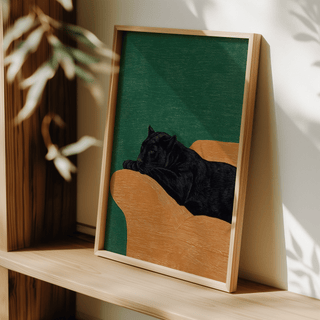 Big Cat Art Print of a black panther lying on a brown surface with a green background leaning on a wooden shelf with plant shadows
