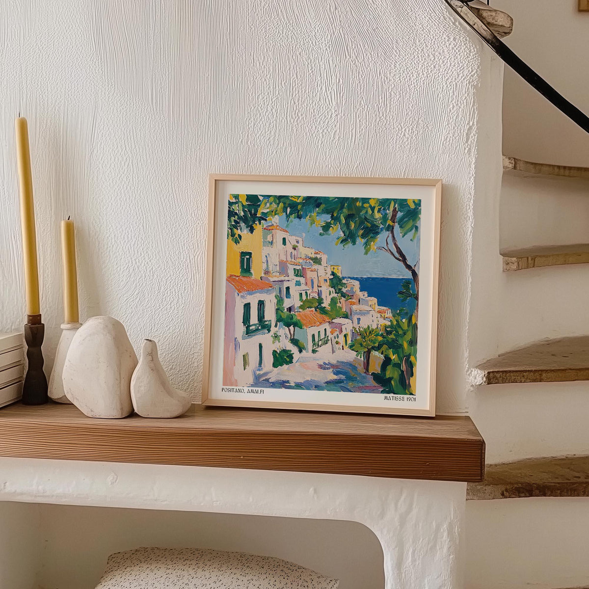 Print of Positano Art showing a colourful Italian coastal village leaning on a wooden mantel with candles