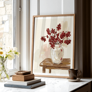 Red Berries Poster print leaning on a white windowsill with a cup and stacked books nearby