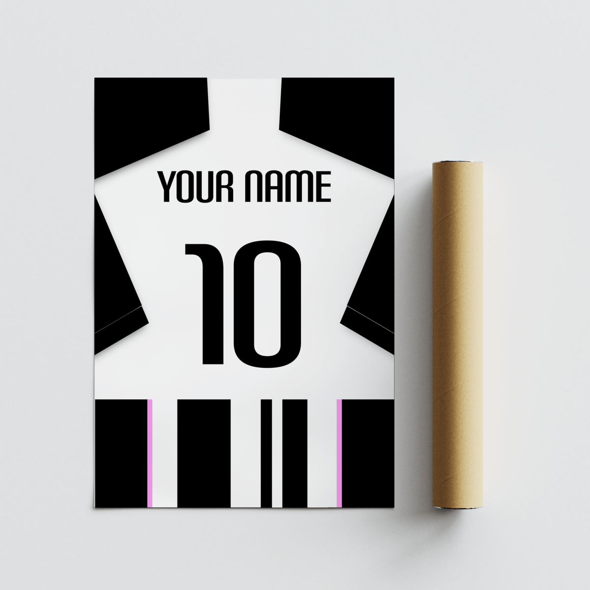 Football Shirt Poster in Black and White Stripes with Pink Accents beside a brown packaging tube