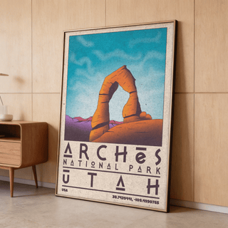 Print leaning on floor of Delicate Arch in orange and purple tones near a wooden cabinet