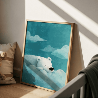 Print leaning on a floor depicting a sleeping polar bear among clouds in blue tones beside a cushion