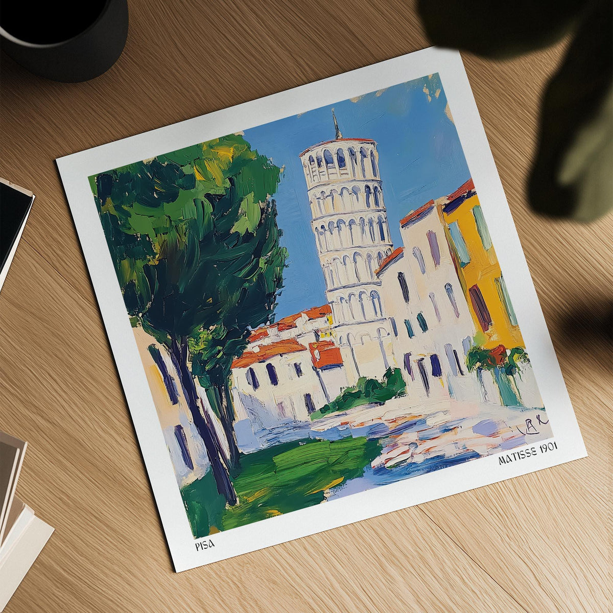Leaning Tower of Pisa Pictures showing the illustration with green trees and blue sky on a wooden table next to a cup