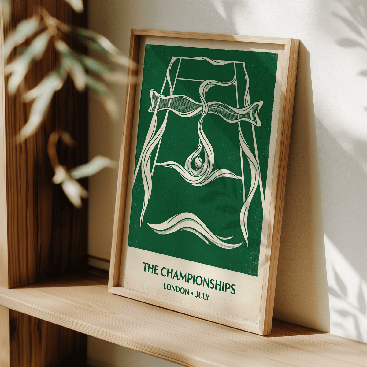 Framed Grass Court Tennis wall art with a vintage green and cream illustration leaning on a wooden shelf