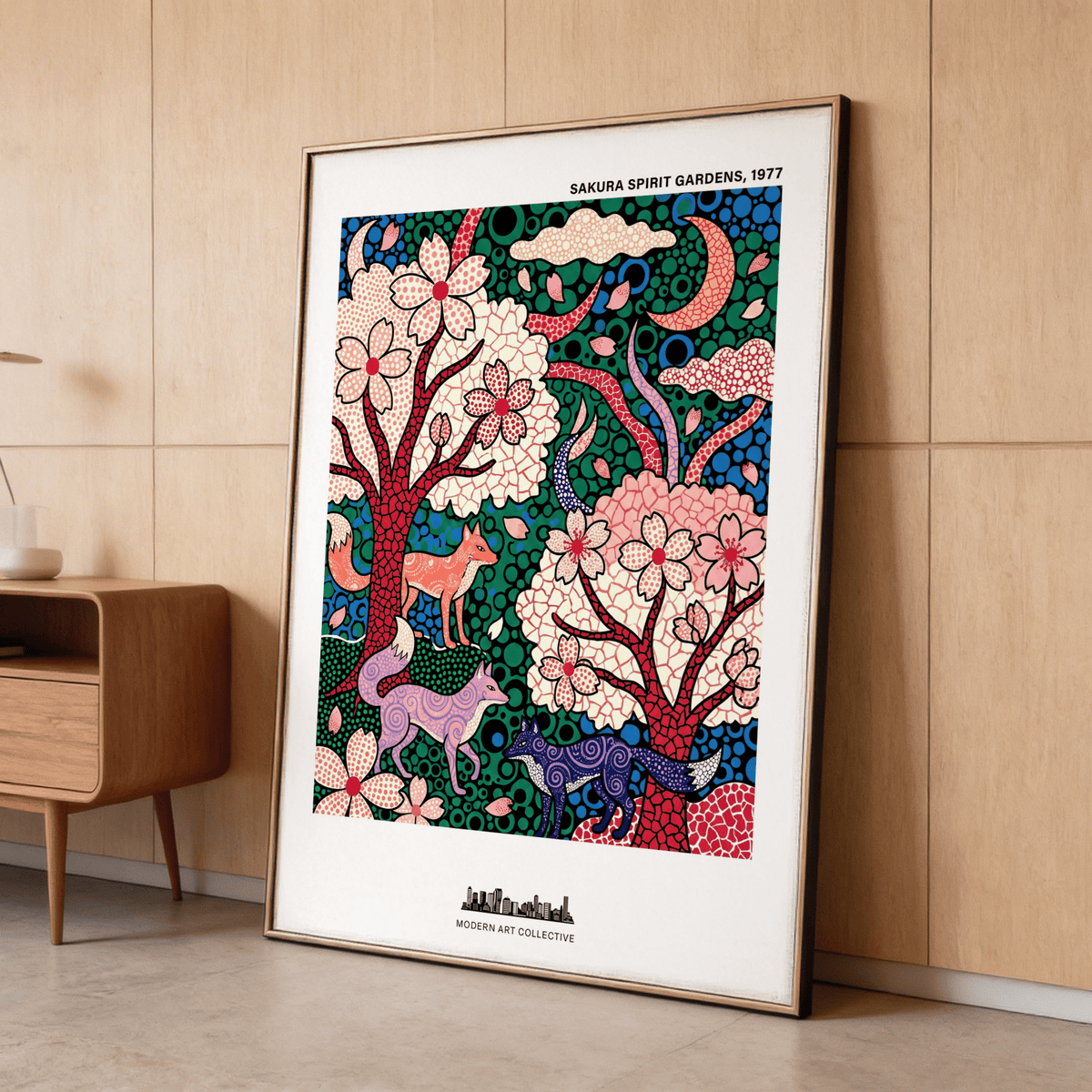 Print leaning on a floor with foxes in cherry blossom garden in red, green and purple colours