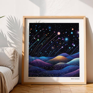 Framed Galaxy wall art of abstract shooting stars and colourful hills leaning on a wooden floor beside a sofa