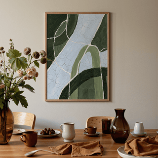 Green and blue art abstract stream in greens and blues above a dining table with ceramic cups and vases
