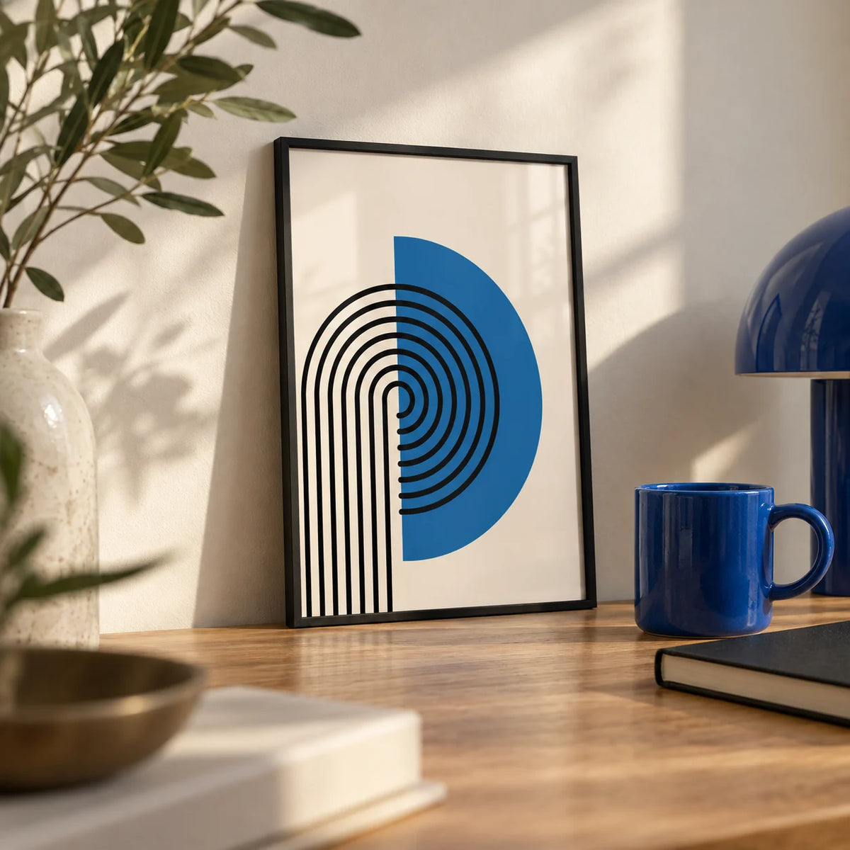 Abstract Arch Print, a small A4 framed print leaning on an oak desk