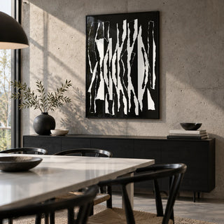 Abstract Black And White, framed on the wall of a modern dining room with a concrete wall