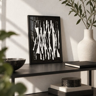 Abstract Black And White, a small A4 framed print leaning on a black metal shelf in a living room