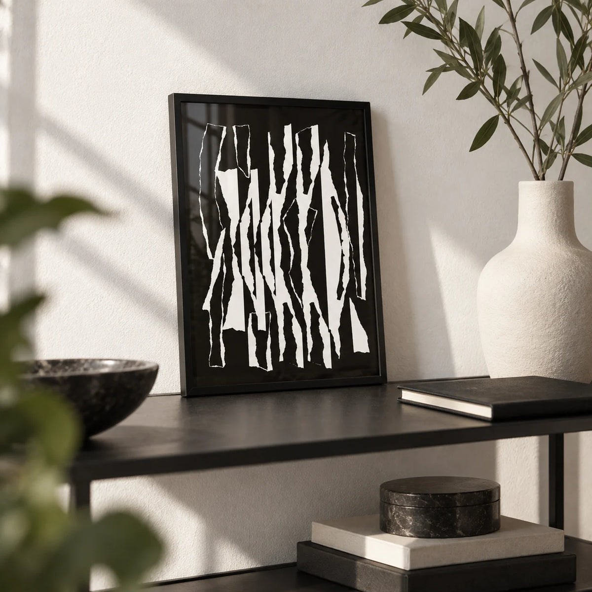 Abstract Black And White, a small A4 framed print leaning on a black metal shelf in a living room