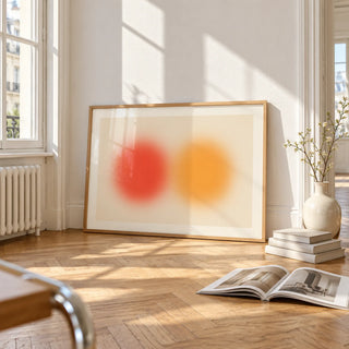 Abstract Sun Wall Art, framed and leaning on the parquet floor of a bright living room