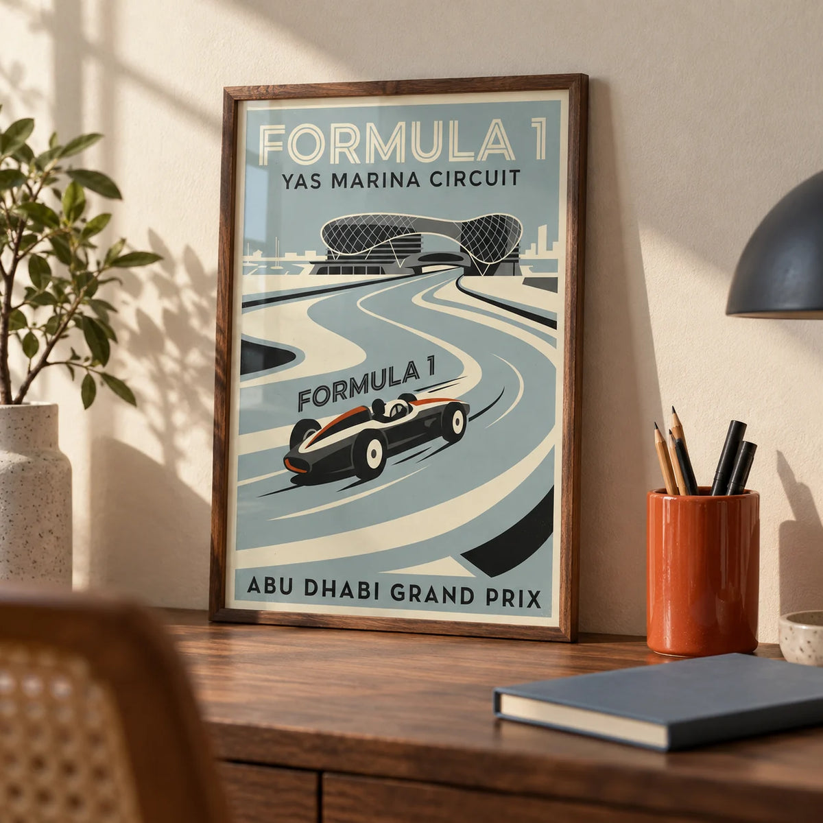 Abu Dhabi Race Circuit Poster, a small A4 framed print leaning on a walnut desk