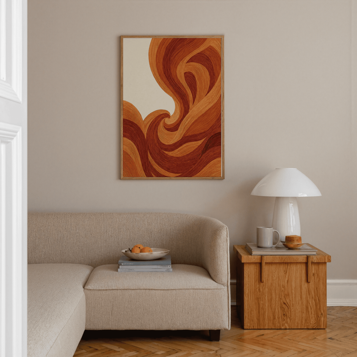 Abstract Wave Art Print on a wall in a living room with curved orange and red wave lines above a beige sofa and wooden side table