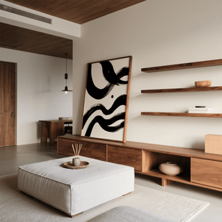 Black and white paintings abstract leaning print with bold ink waves on a wooden cabinet next to shelves