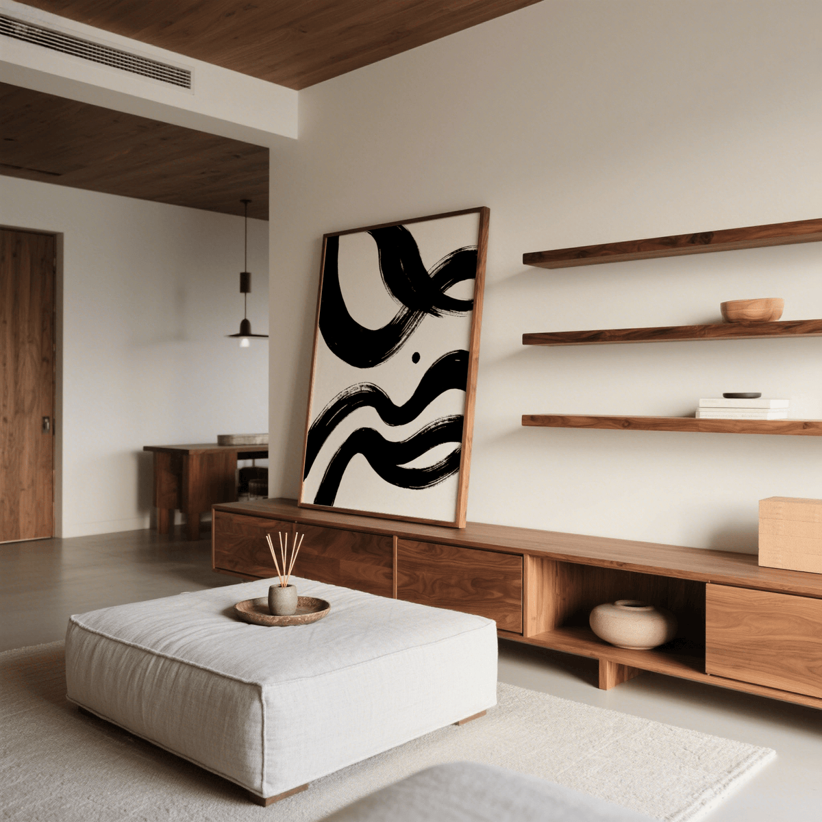 Black and white paintings abstract leaning print with bold ink waves on a wooden cabinet next to shelves