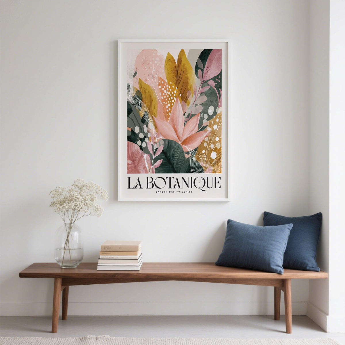 Flower prints framed print of abstract botanical leaves in pink green and gold above a wooden bench with cushion