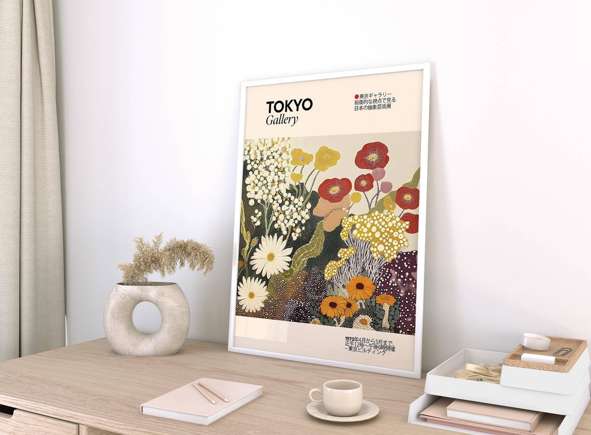Wildflower wall art leaning on a desk with a white round vase holding dried grass