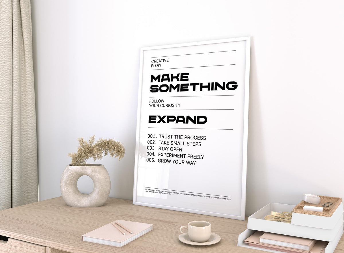 Quotes for Room Wall print leaning on a desk with a ceramic vase and books nearby