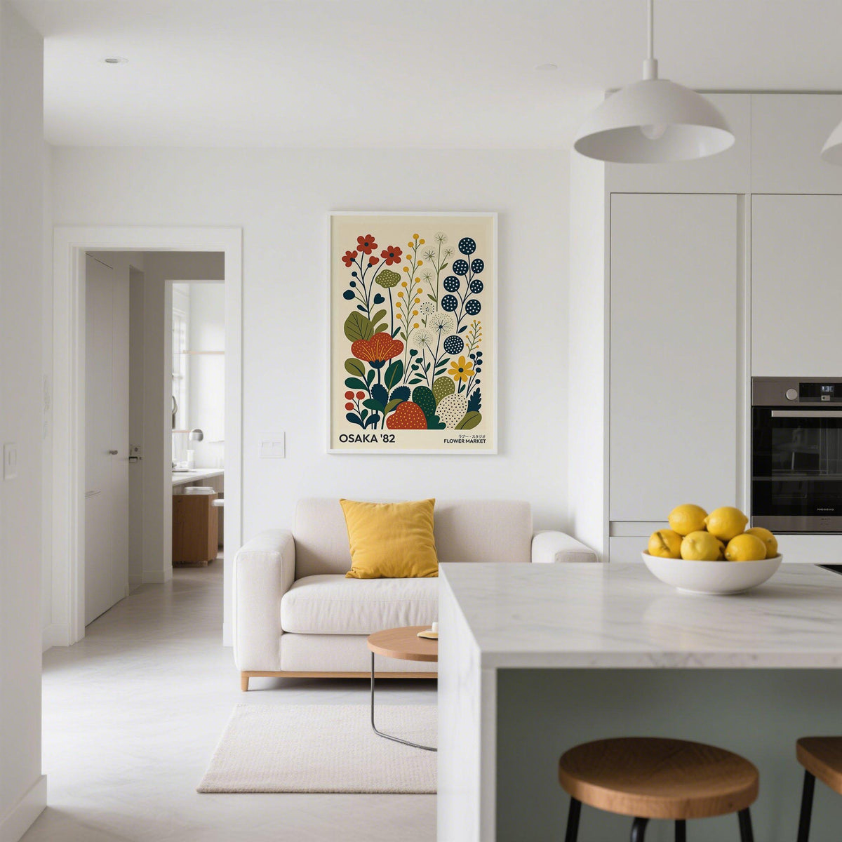 Nature artwork print of stylised flowers in red yellow and green above a sofa in a white kitchen lounge