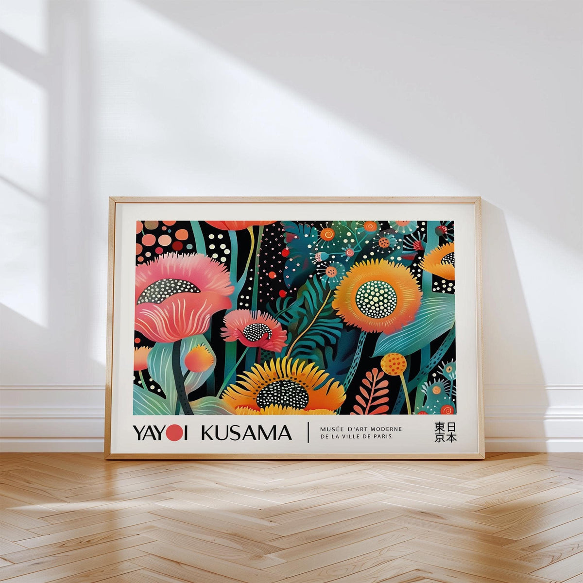 Floral wall art with kaleidoscope flowers in yellow and pink leaning on a wooden floor