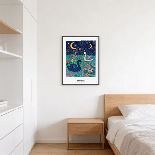 Swan art print in black frame above a wooden bedside table in a bedroom with white walls