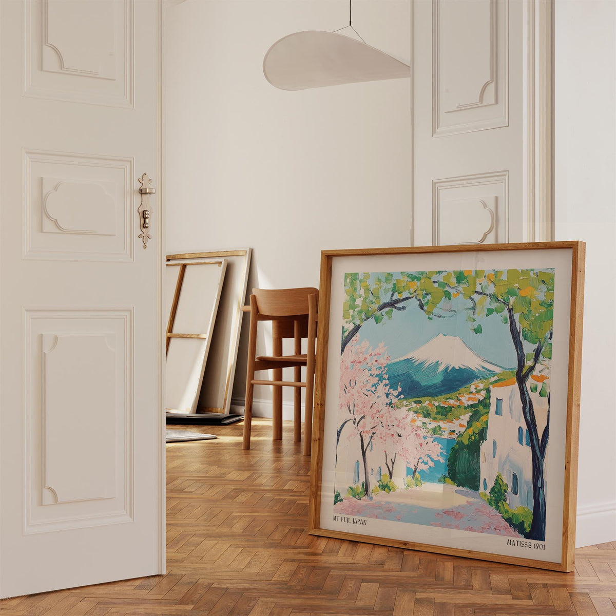 Japan poster leaning on wooden parquet floor with chair in bright room