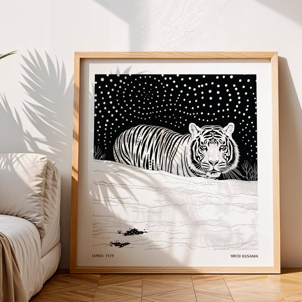 Framed white tiger art with black starry sky leaning on the floor near a sofa