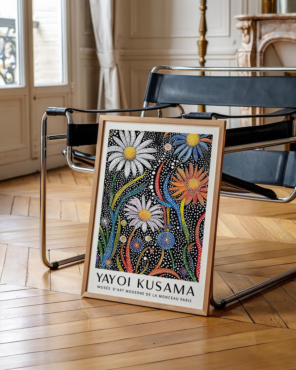 Flower print for framing leaning on a black and chrome chair with hardwood floor