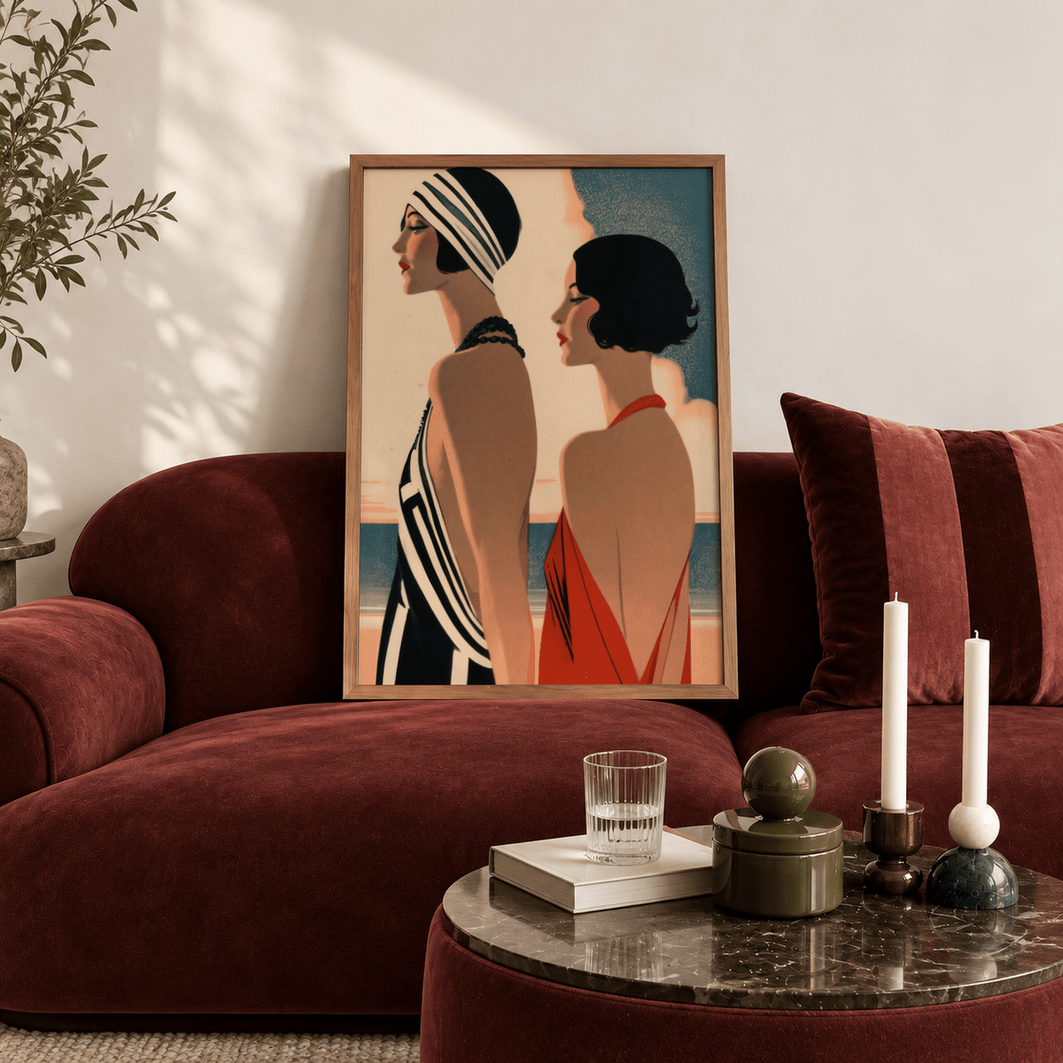 Art Deco Riviera Fashion Print leaning on a deep red velvet sofa with a side table and candles