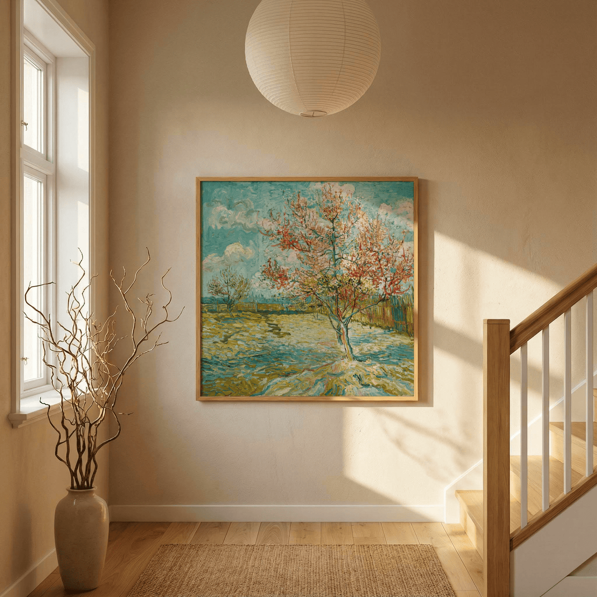 Impressionist wall art of a flowering tree with blue sky in a bright hallway near a staircase and vase
