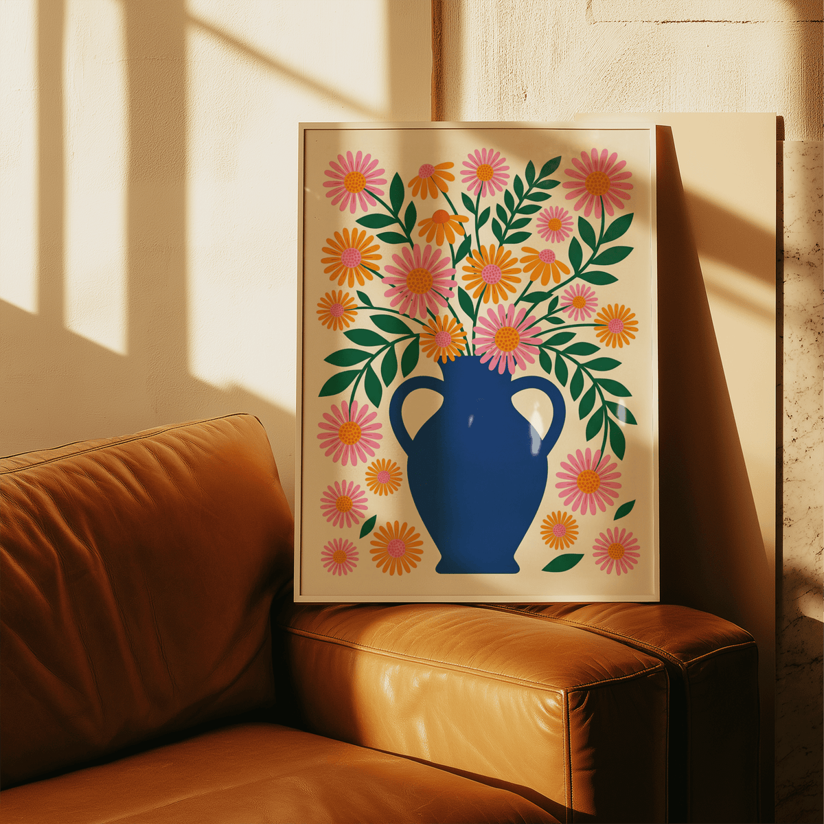 Print leaning on a tan leather sofa of a floral vase with orange and pink flowers in illustration style