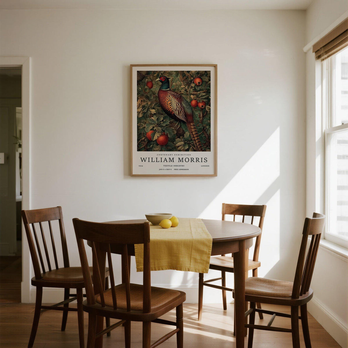 Pheasant wall art featuring a bird with red fruit hanging above a dining table with a yellow runner