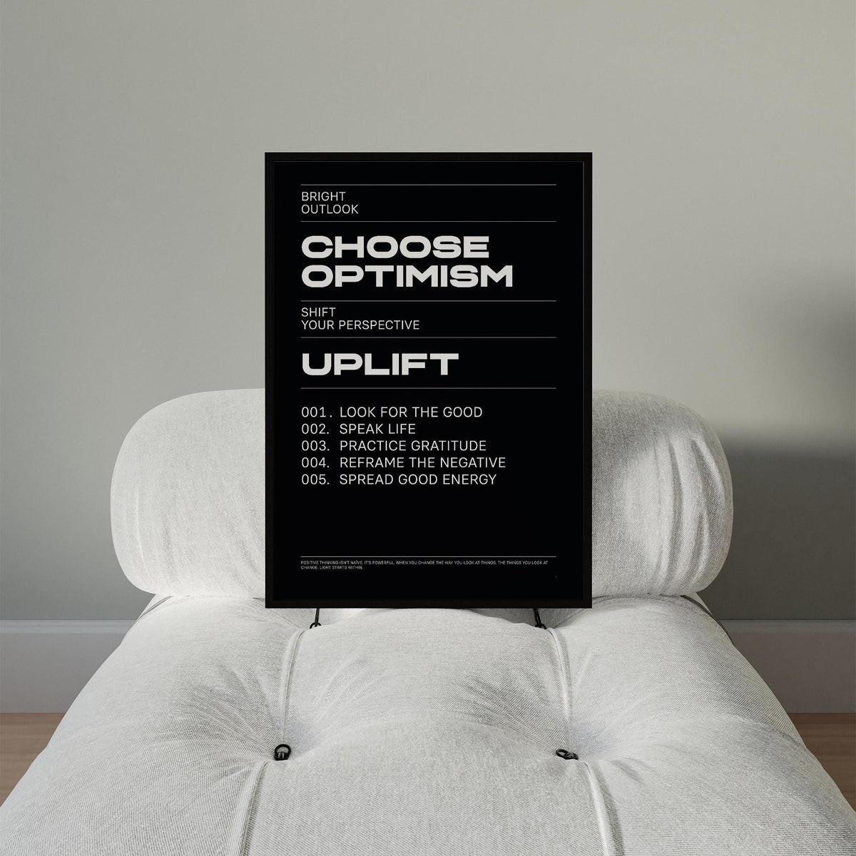 Affirmation Print with Choose Optimism motivational text in black and white on a white chair