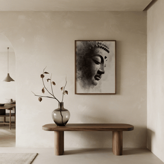 Framed Zen Statue Face Art Print of a black and white buddha statue face above a wooden table with vase and dried flowers