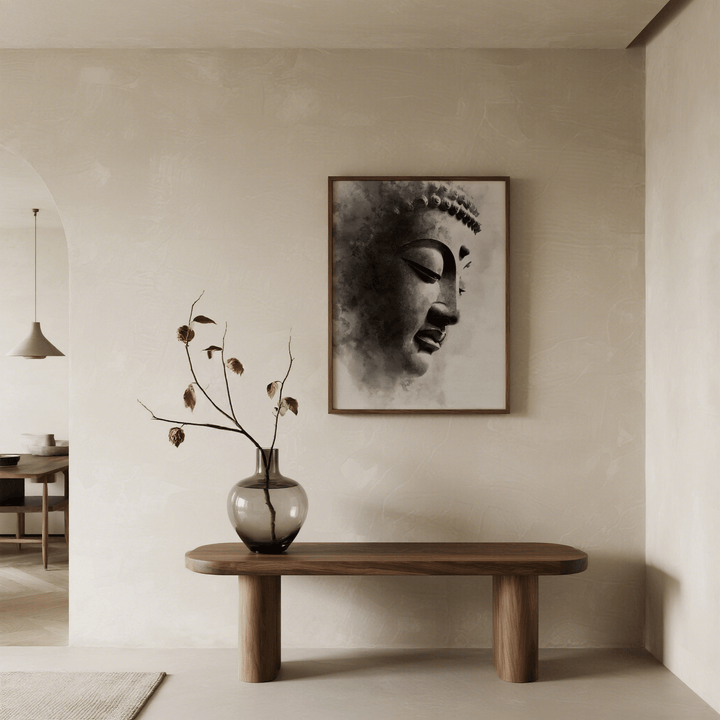 Framed Zen Statue Face Art Print of a black and white buddha statue face above a wooden table with vase and dried flowers