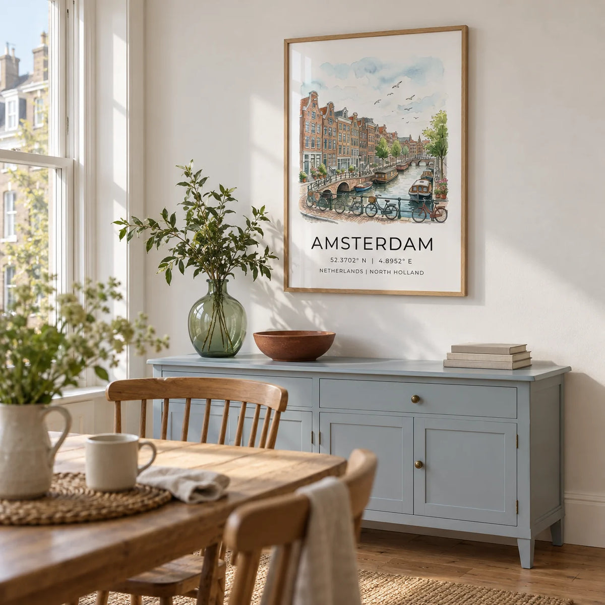 Amsterdam Canal Art Print, framed on the wall of a light dining room in a characterful UK city flat with a white wall and a tall sash window